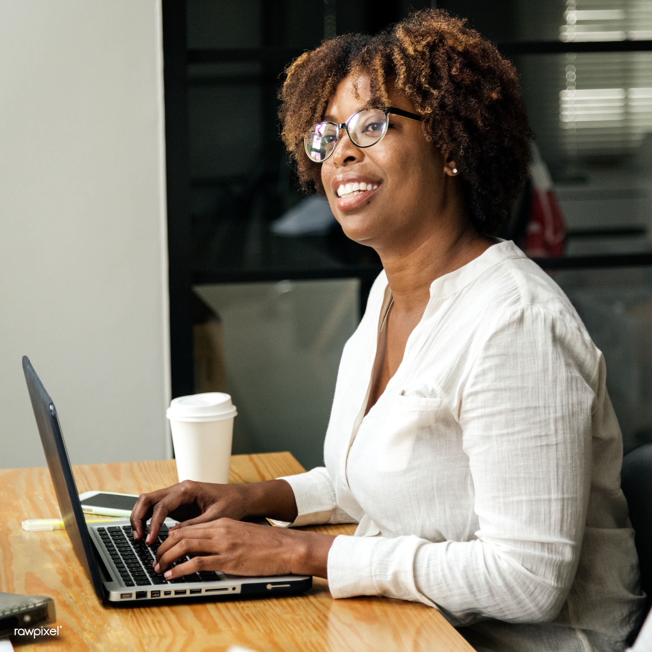 Person using a laptop in a meeting room